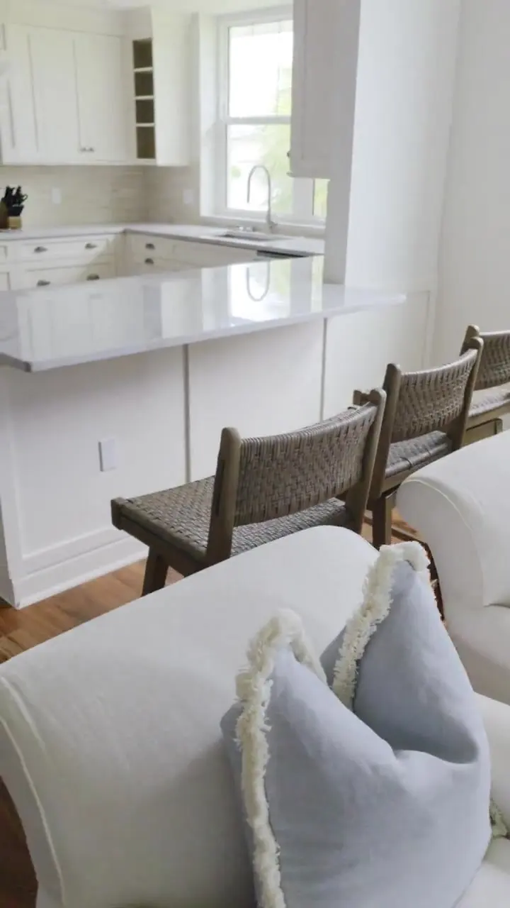Finished kitchen with cabinetry sprayed in warm white, granite peninsula and crown detail carried around the room.