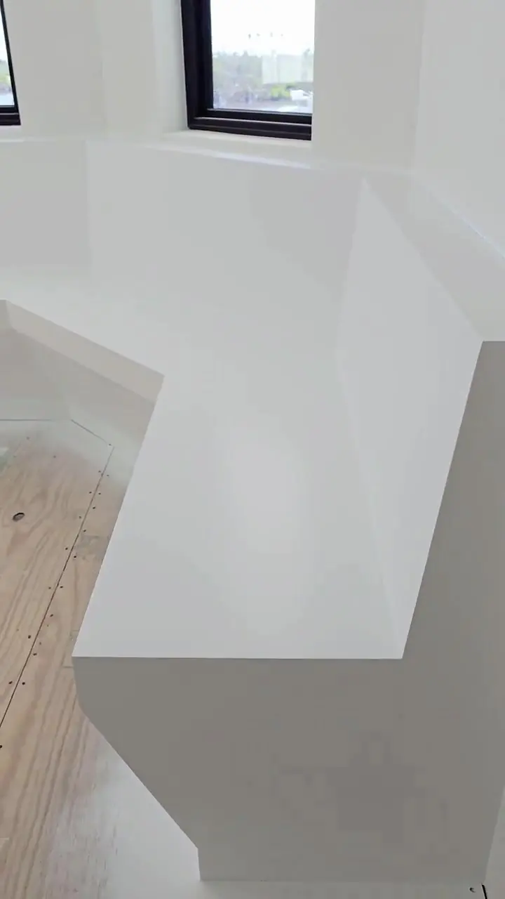 A waterfront room during build-out, walls finished and floors still protected ahead of installation.