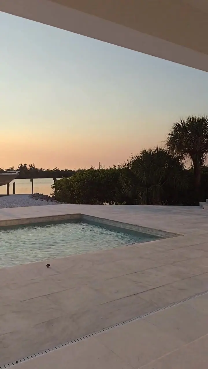 Sunset across the water from a finished waterfront terrace on Florida's Gulf Coast.