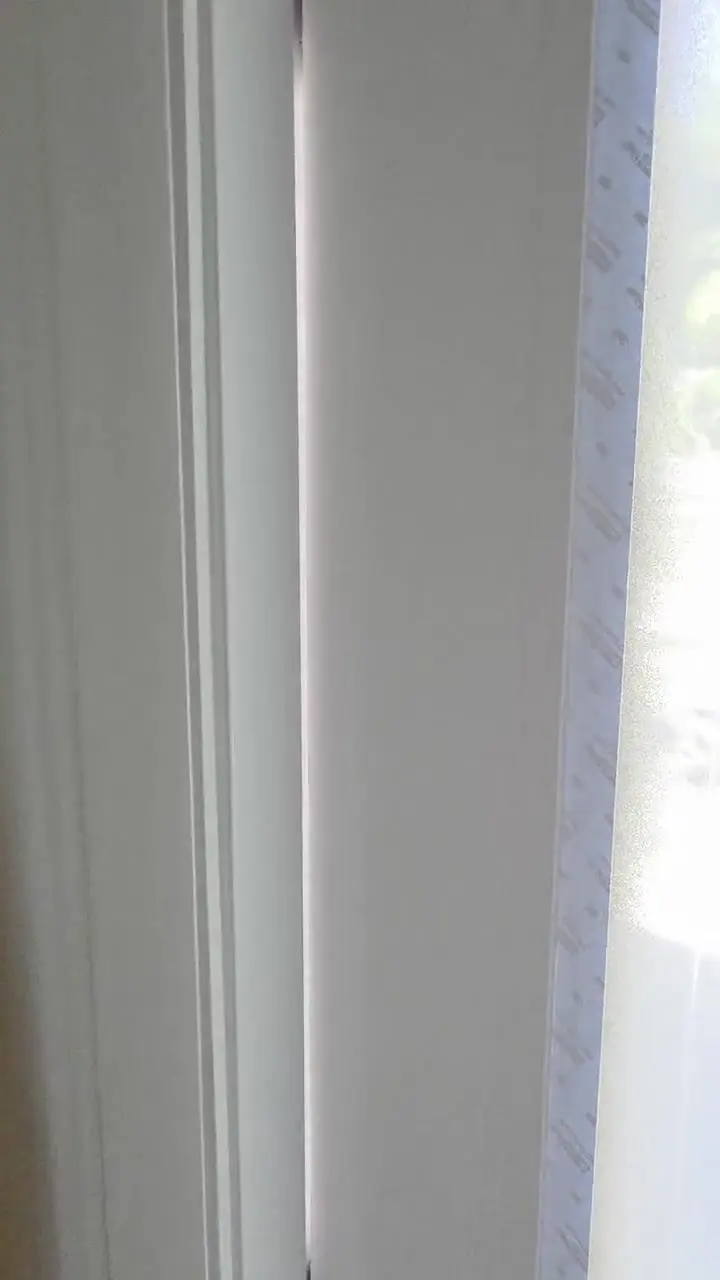 Close detail of window casing and stool finished flush against the wall.